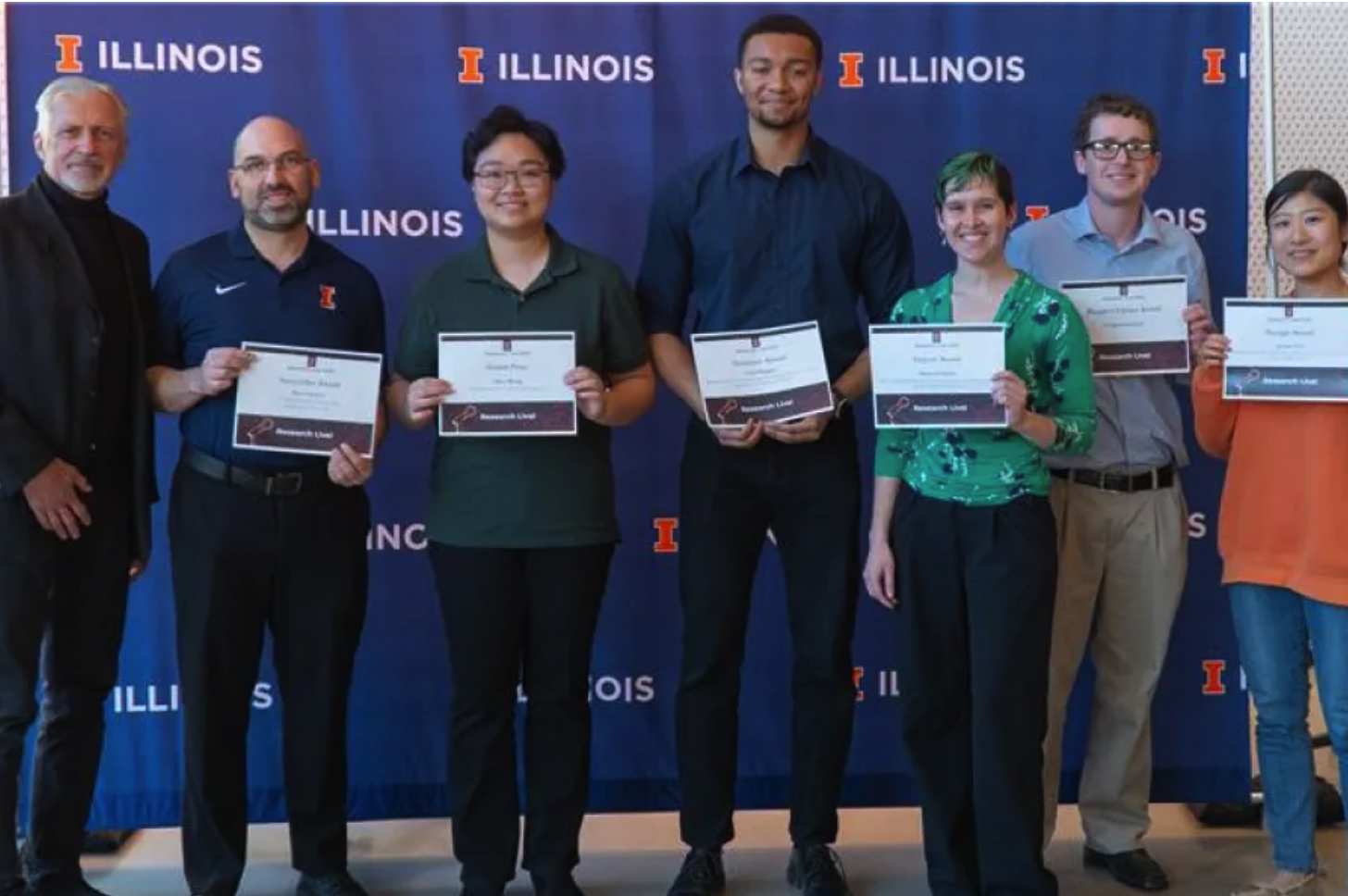 People holding certificates smiling